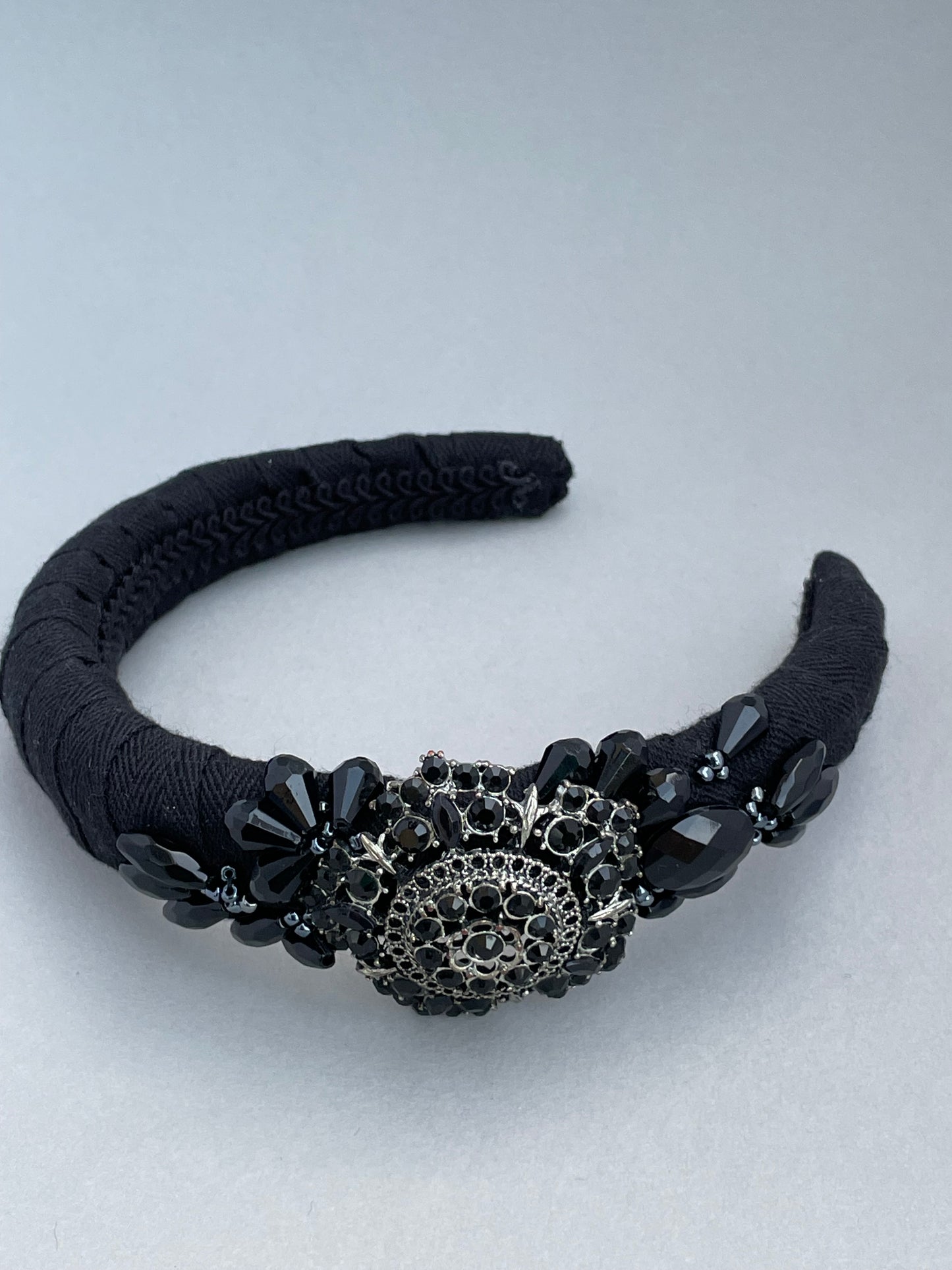 Black padded headband with black brooch and bead detail