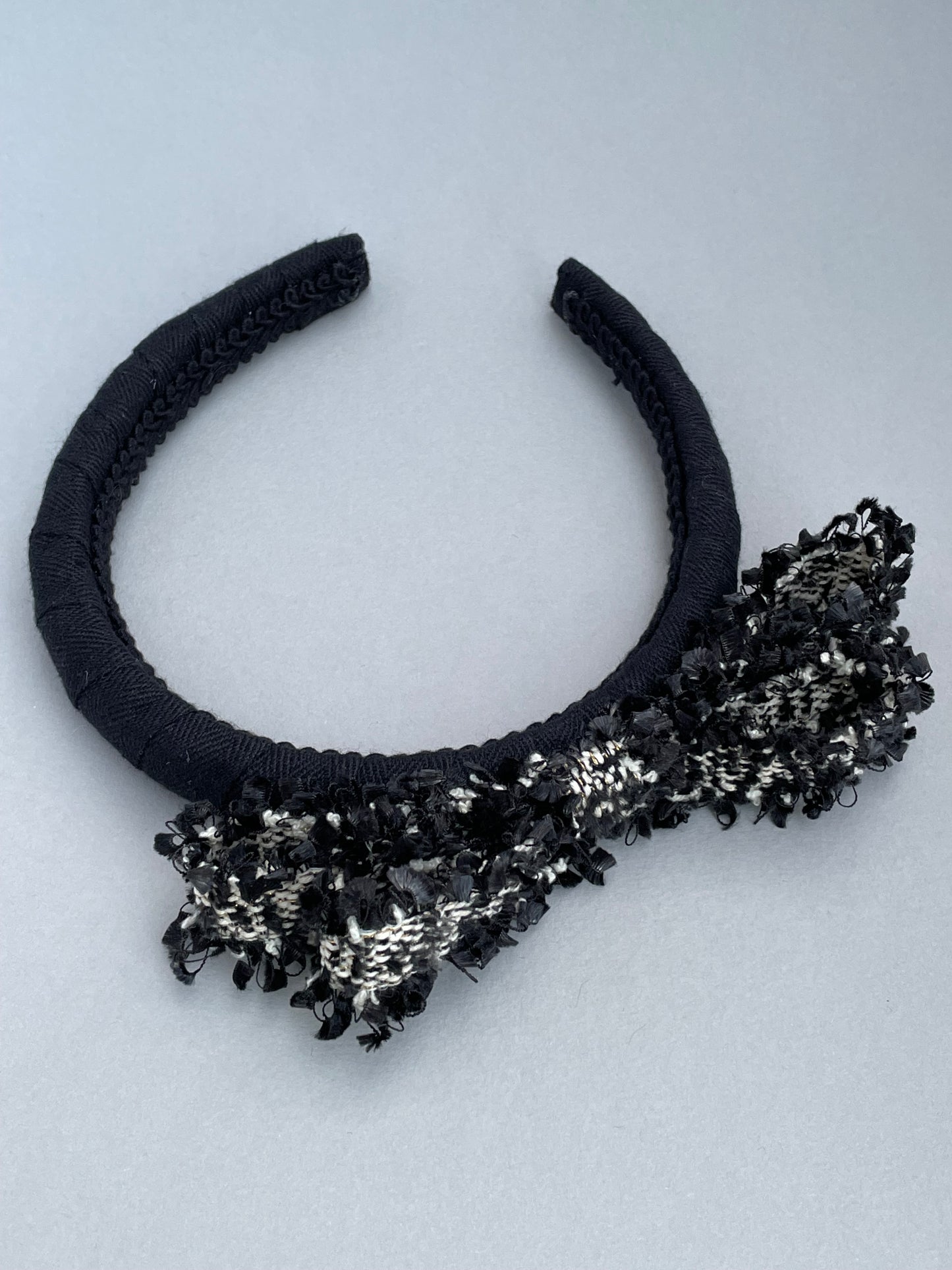 Black padded headband with black and white frayed edge braid bow