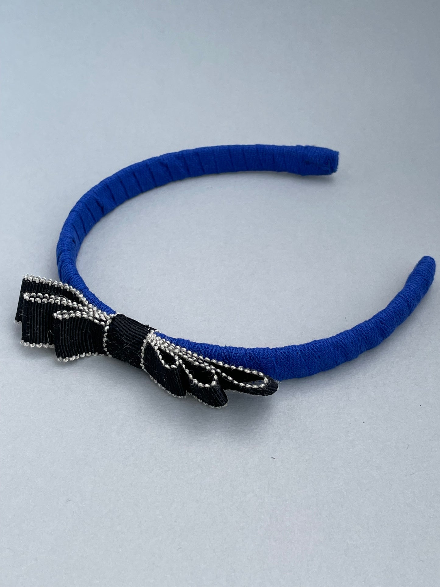 Cobalt blue slim headband with black and white bow