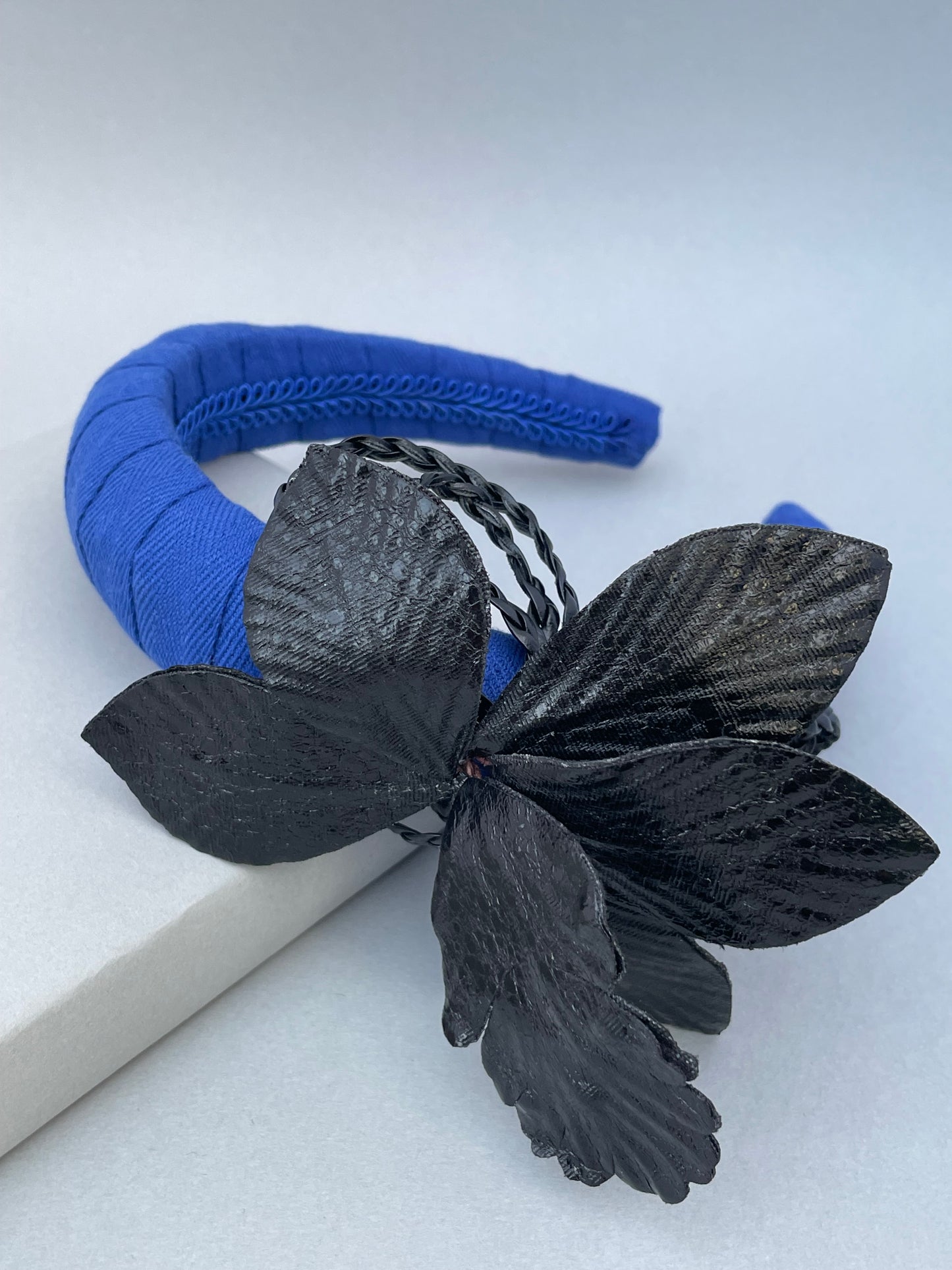 Cobalt blue padded headband with black leatherette orchid