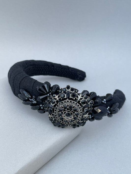 Black padded headband with black brooch and bead detail