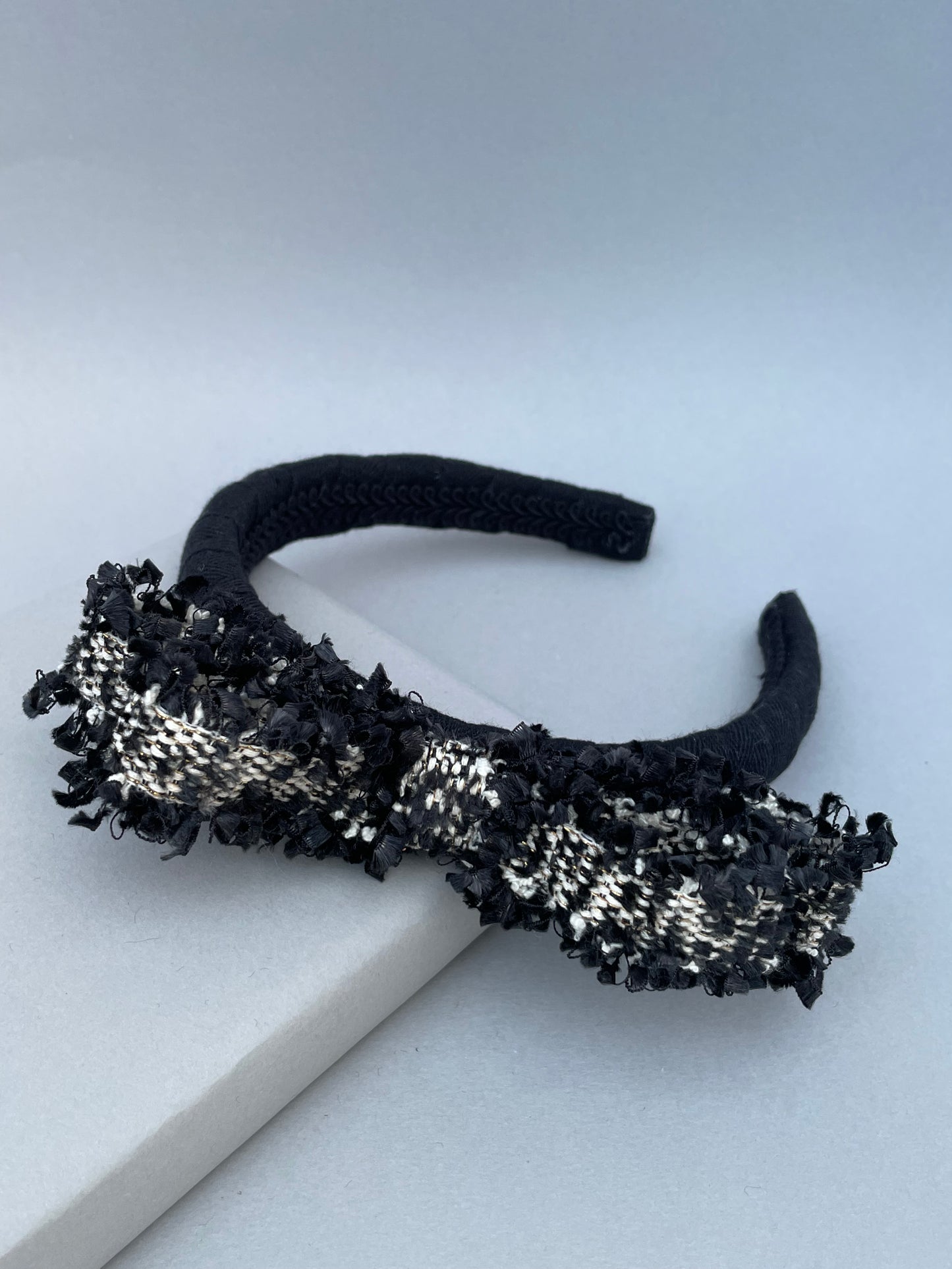 Black padded headband with black and white frayed edge braid bow