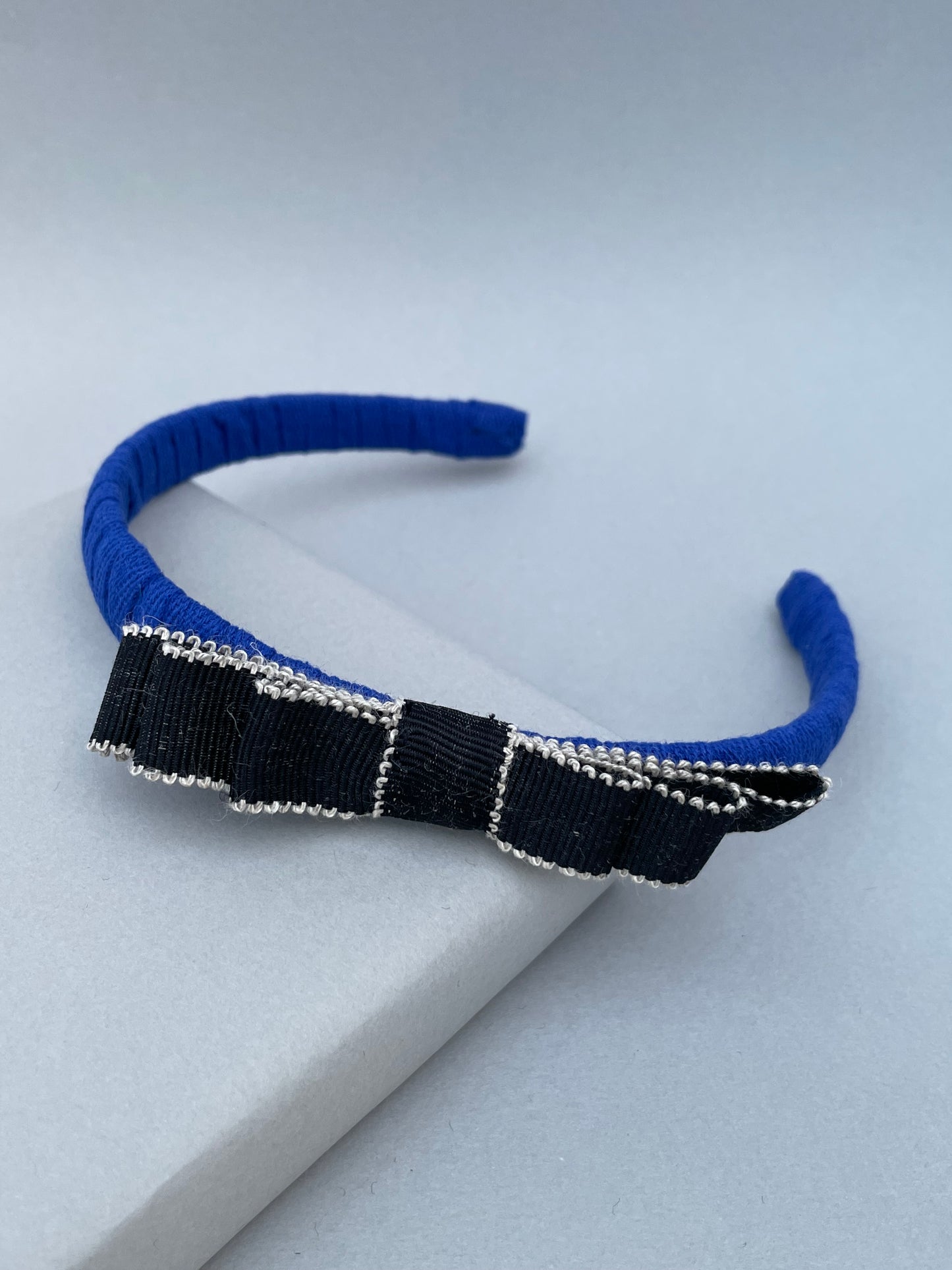 Cobalt blue slim headband with black and white bow