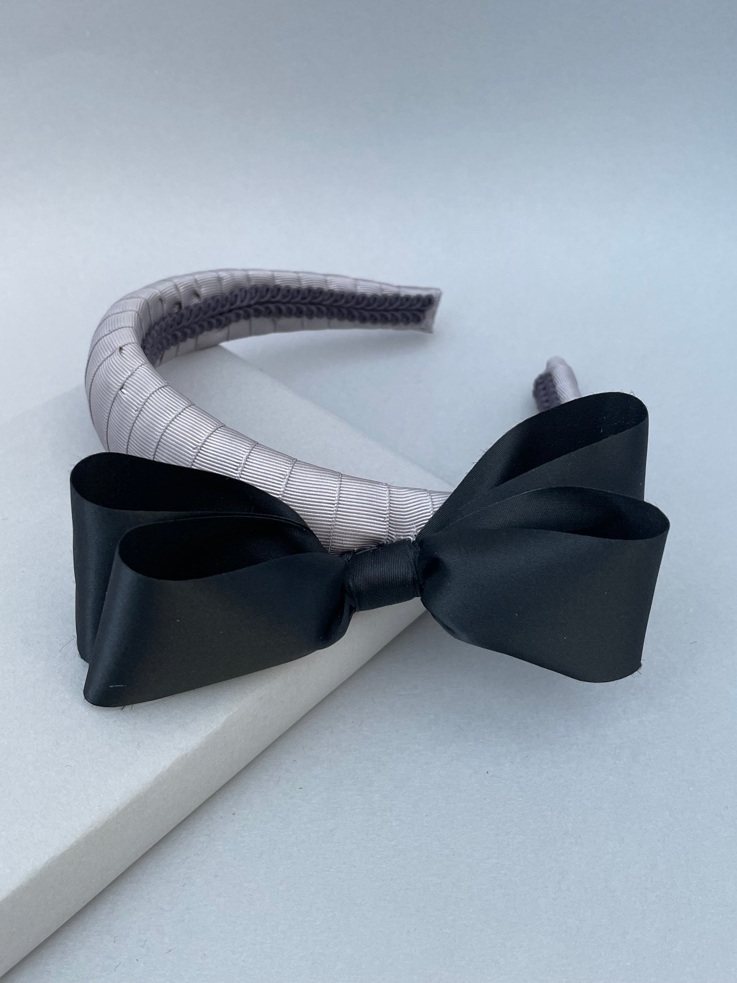 Silver grey padded headband with 1980s black satin vintage bow