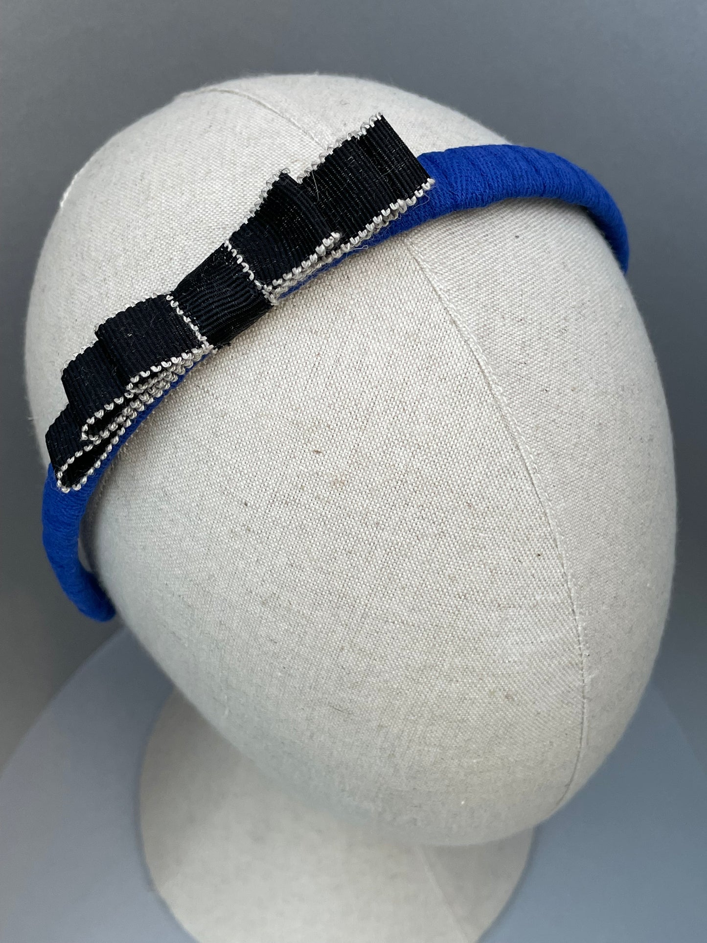 Cobalt blue slim headband with black and white bow