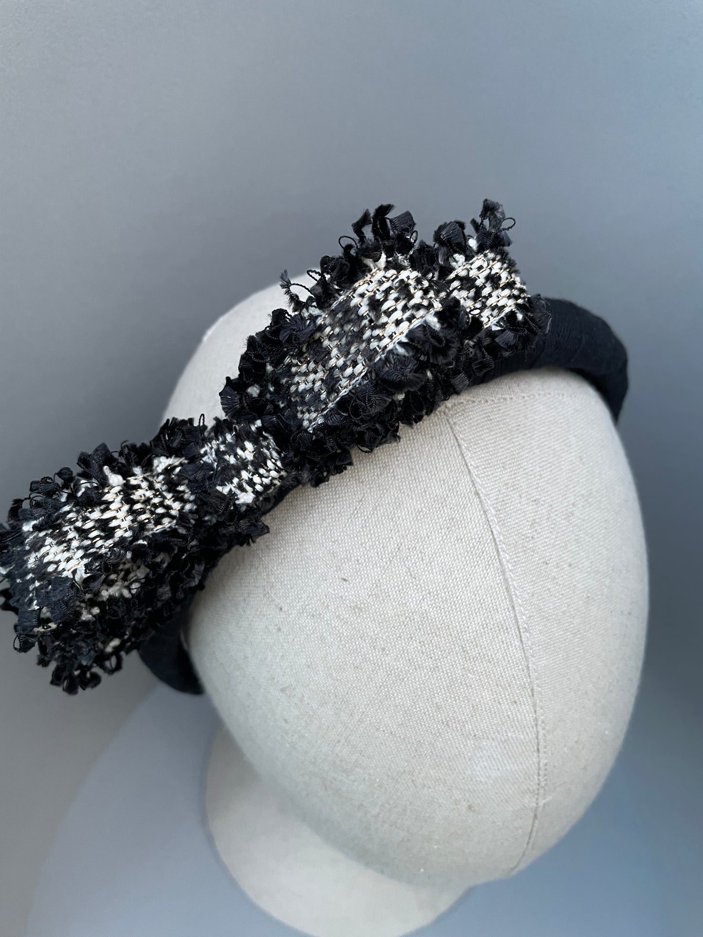 Black padded headband with black and white frayed edge braid bow