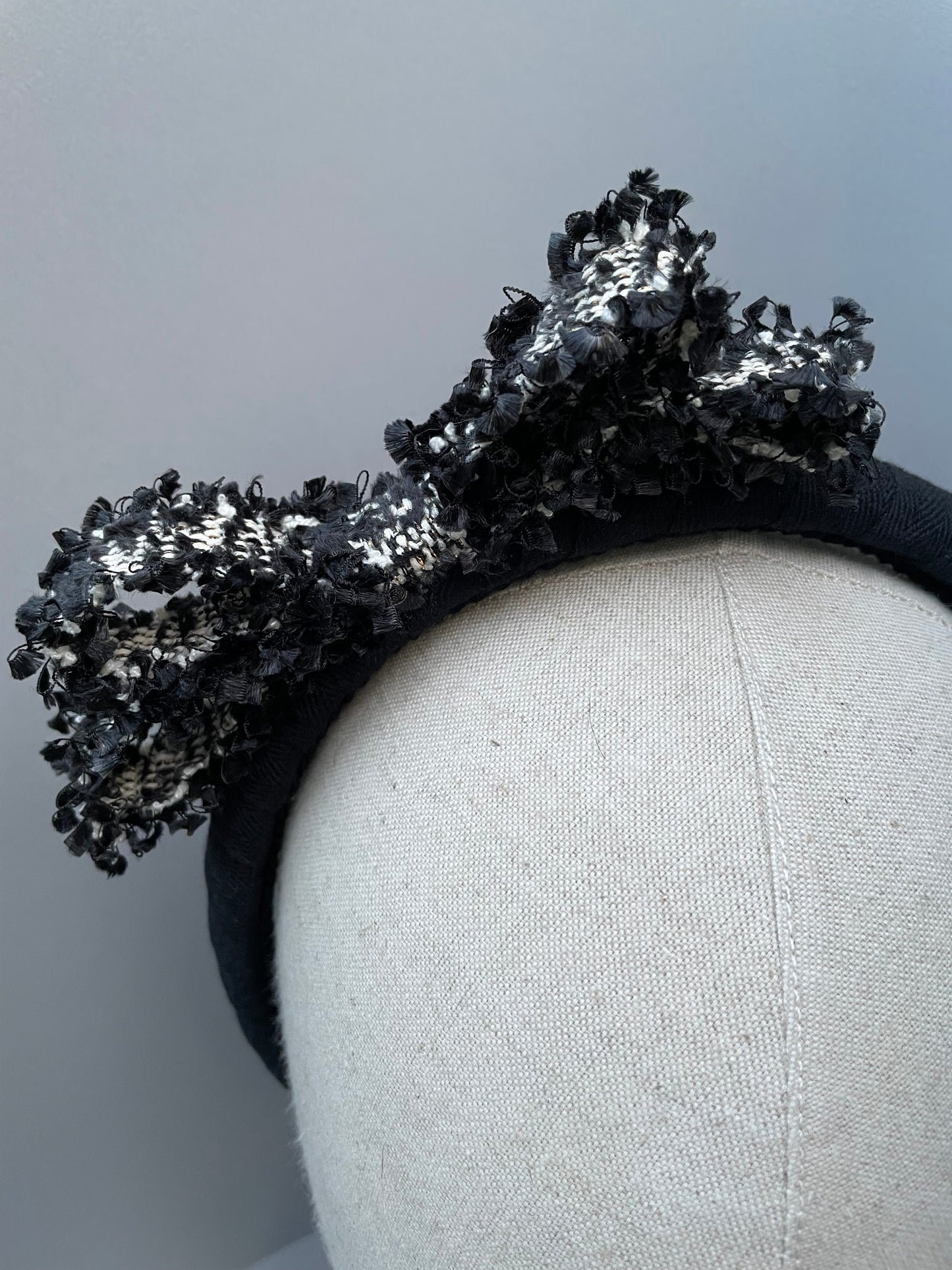 Black padded headband with black and white frayed edge braid bow