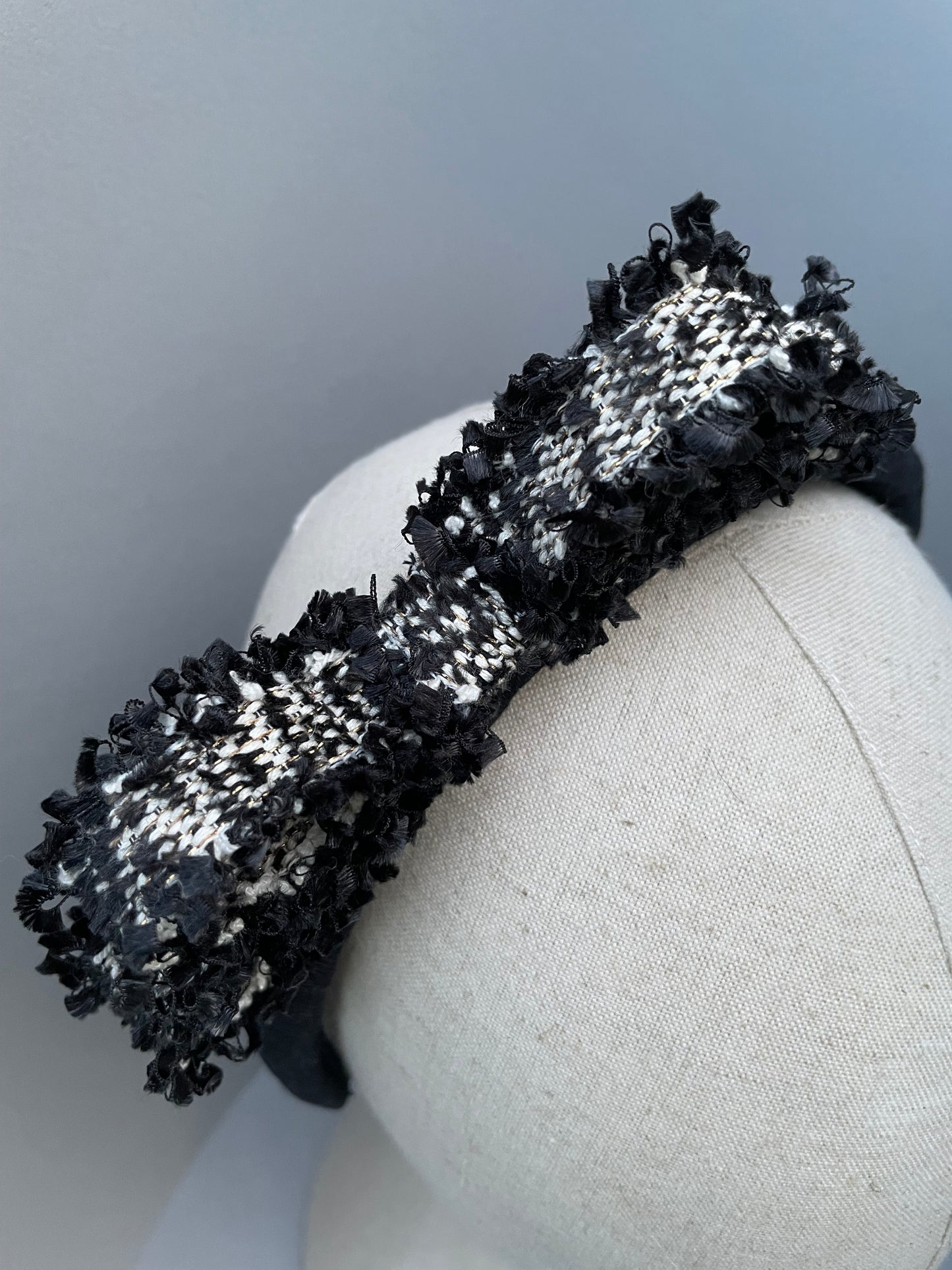 Black padded headband with black and white frayed edge braid bow