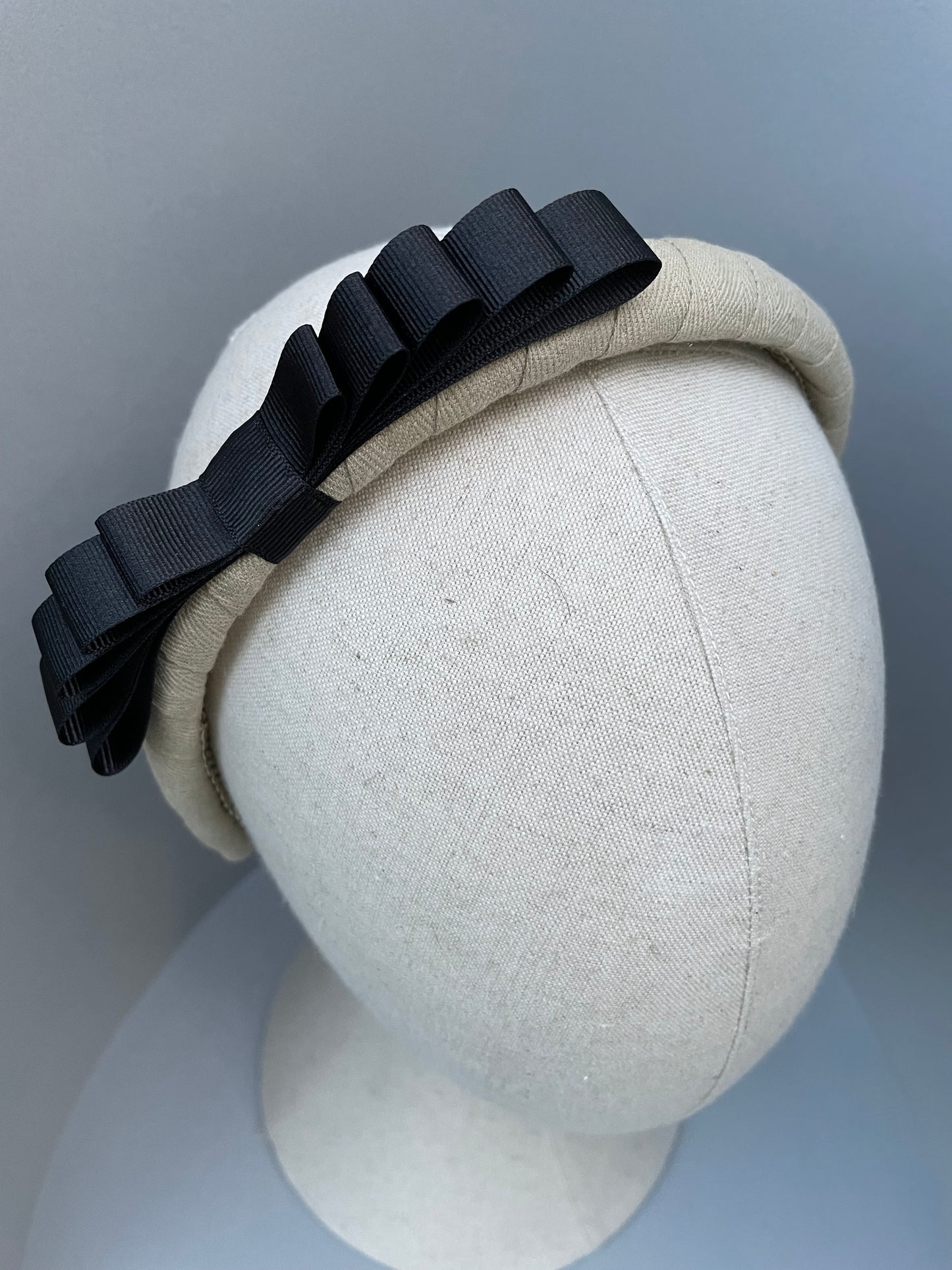 Natural padded headband with black grosgrain ribbon bow