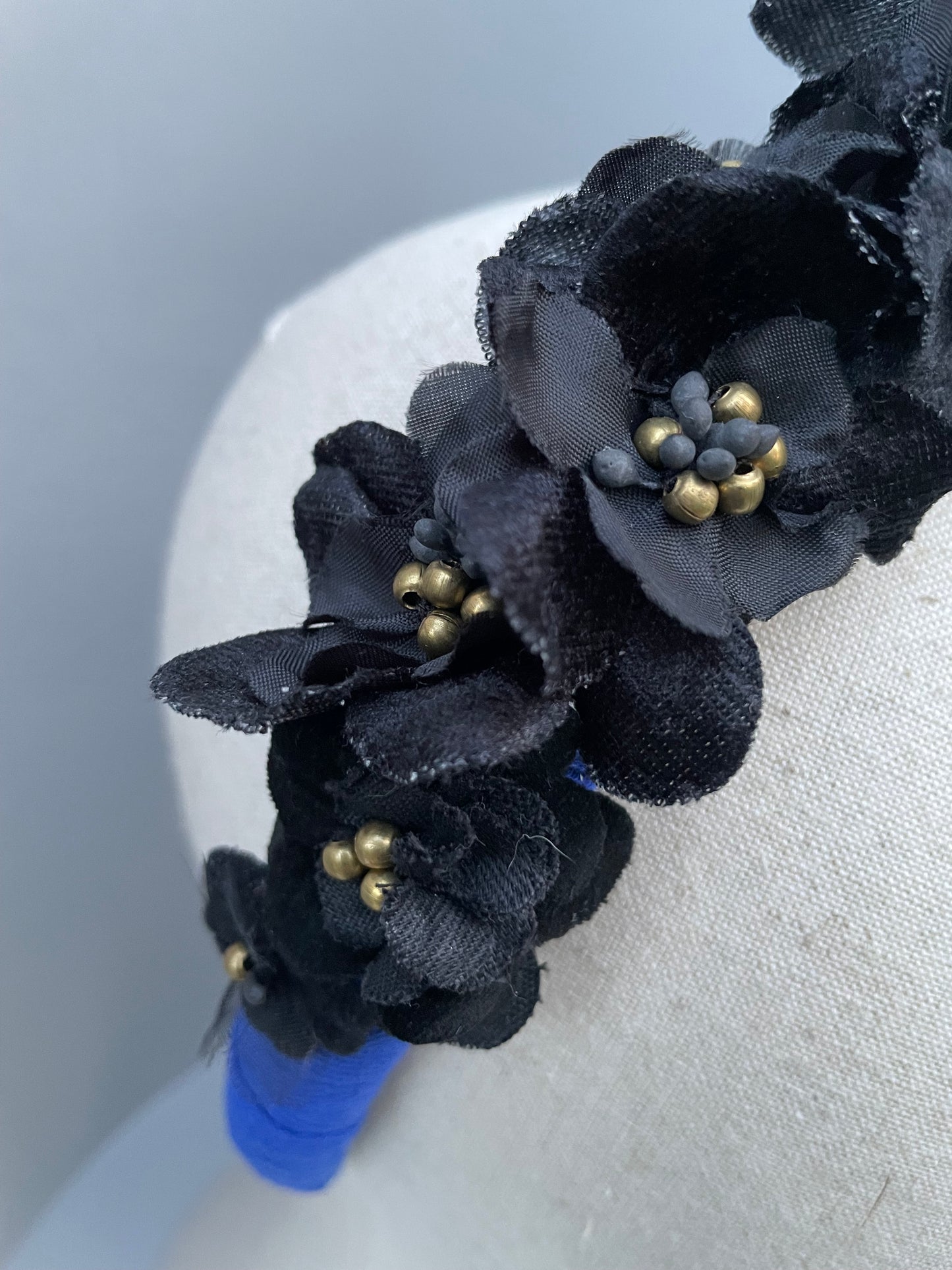 Cobalt blue herringbone padded headband with black velvet and silk flowers