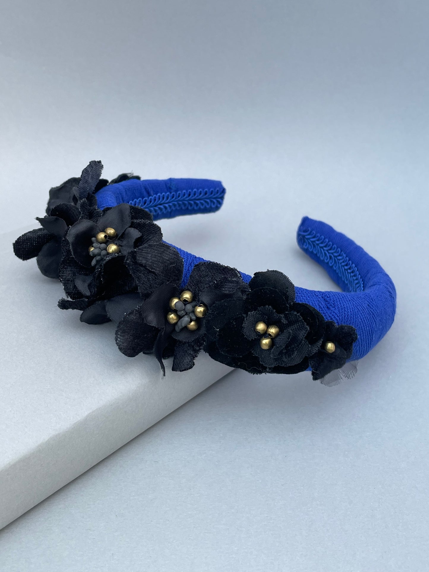 Cobalt blue herringbone padded headband with black velvet and silk flowers